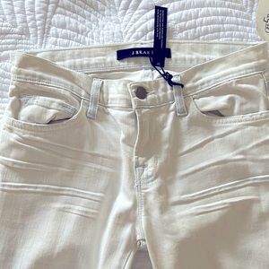 J Brand faded light blue jeans. Frayed at ankles.